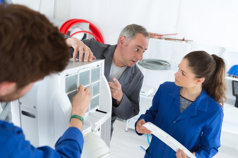 man and woman learning hvac unit